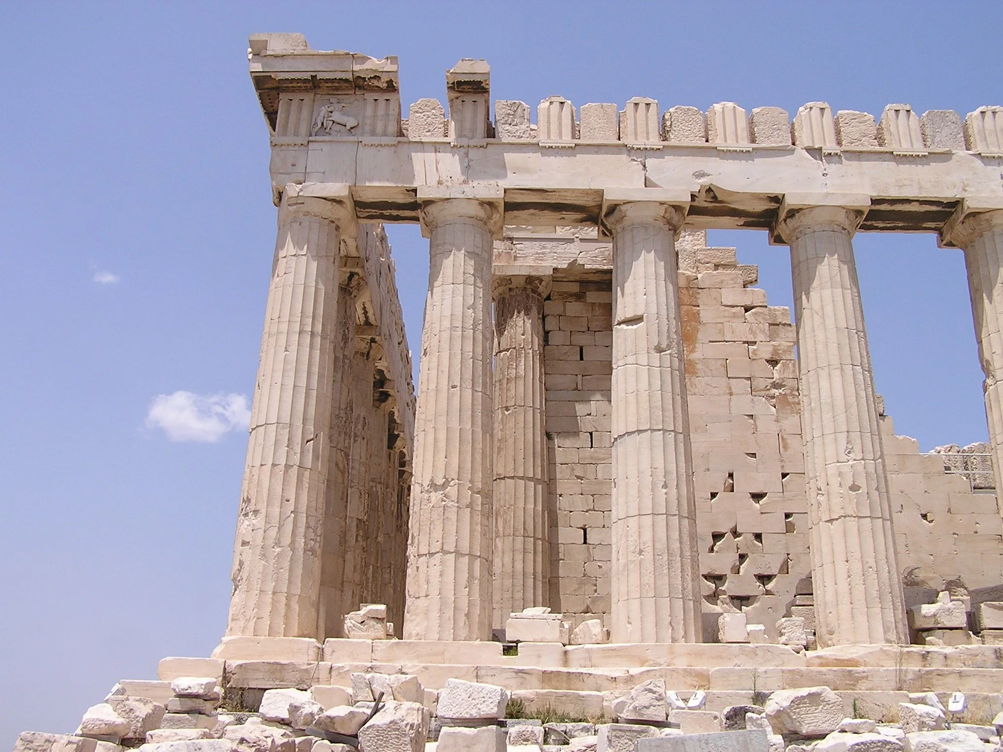 The Parthenon and marble monuments of the Acropolis of Athens seen on the rocky hilltop.