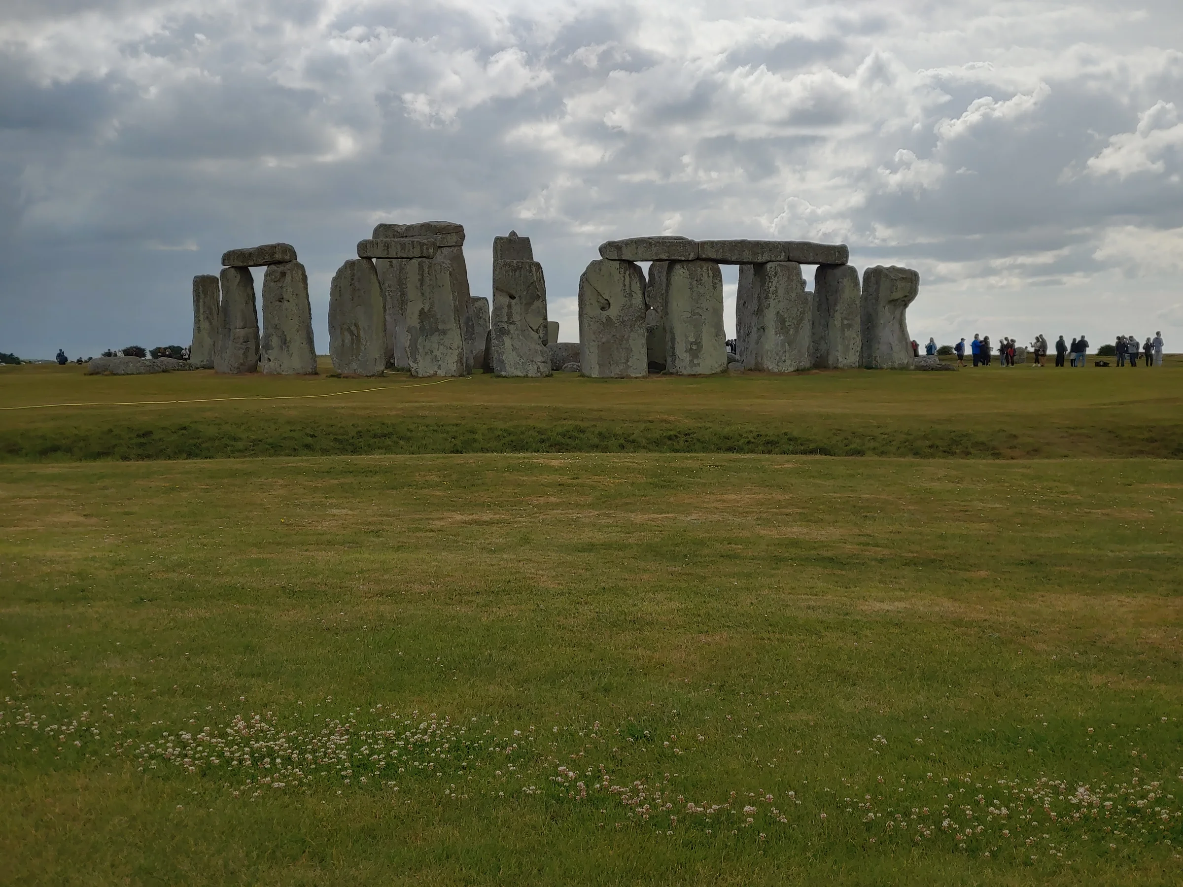Stonehenge standing in open grassland beneath a broad sky in Wiltshire, England.
